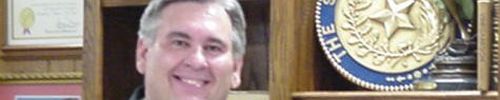 This Texas judge’s head is almost as big as that disc on his bookshelf.